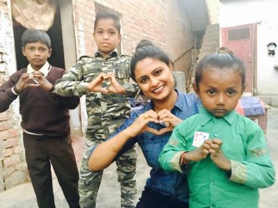A group of kids making heart signs with their hands.
